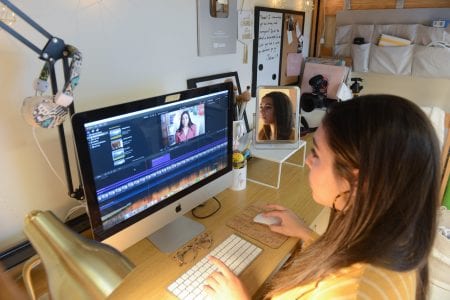 Hannah Ashton Rodriguez works on video edits in her residence hall. 