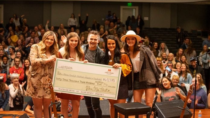 Phi Mu BonnaMu fundraiser with Hunter Hayes presents check for donation