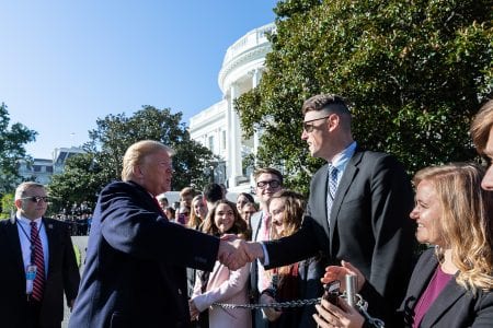Riggs is greeted by President Donald J. Trump as he walks across the South Lawn of the White House to meet the White House interns Thursday, Oct. 18, 2018, prior to boarding Marine One to begin his trip to Montana, Arizona and Nevada. (Official White House Photo by Joyce N. Boghosian)