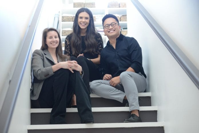 Modern Remains and O'More alumni pose at their studio.