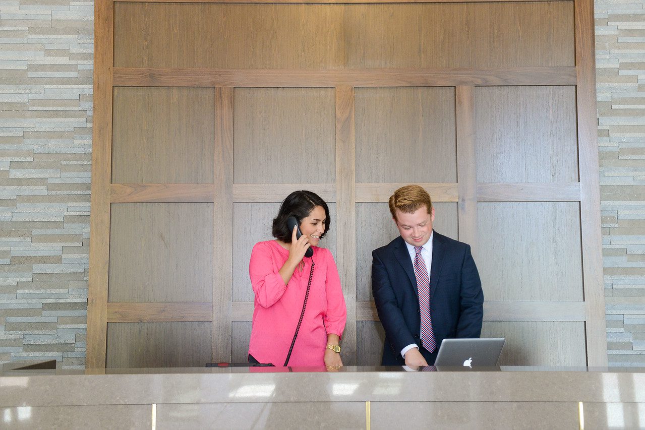 Students Posing at a Hotel Front Desk