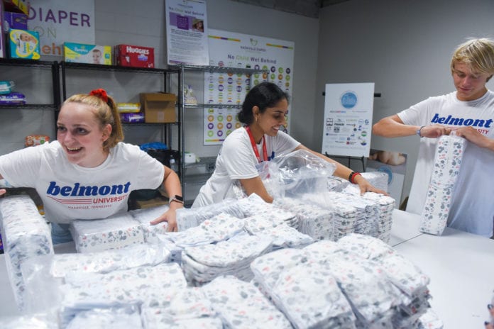 Student packaging diapers for Nashville Diaper Connection as part of annual day of service.
