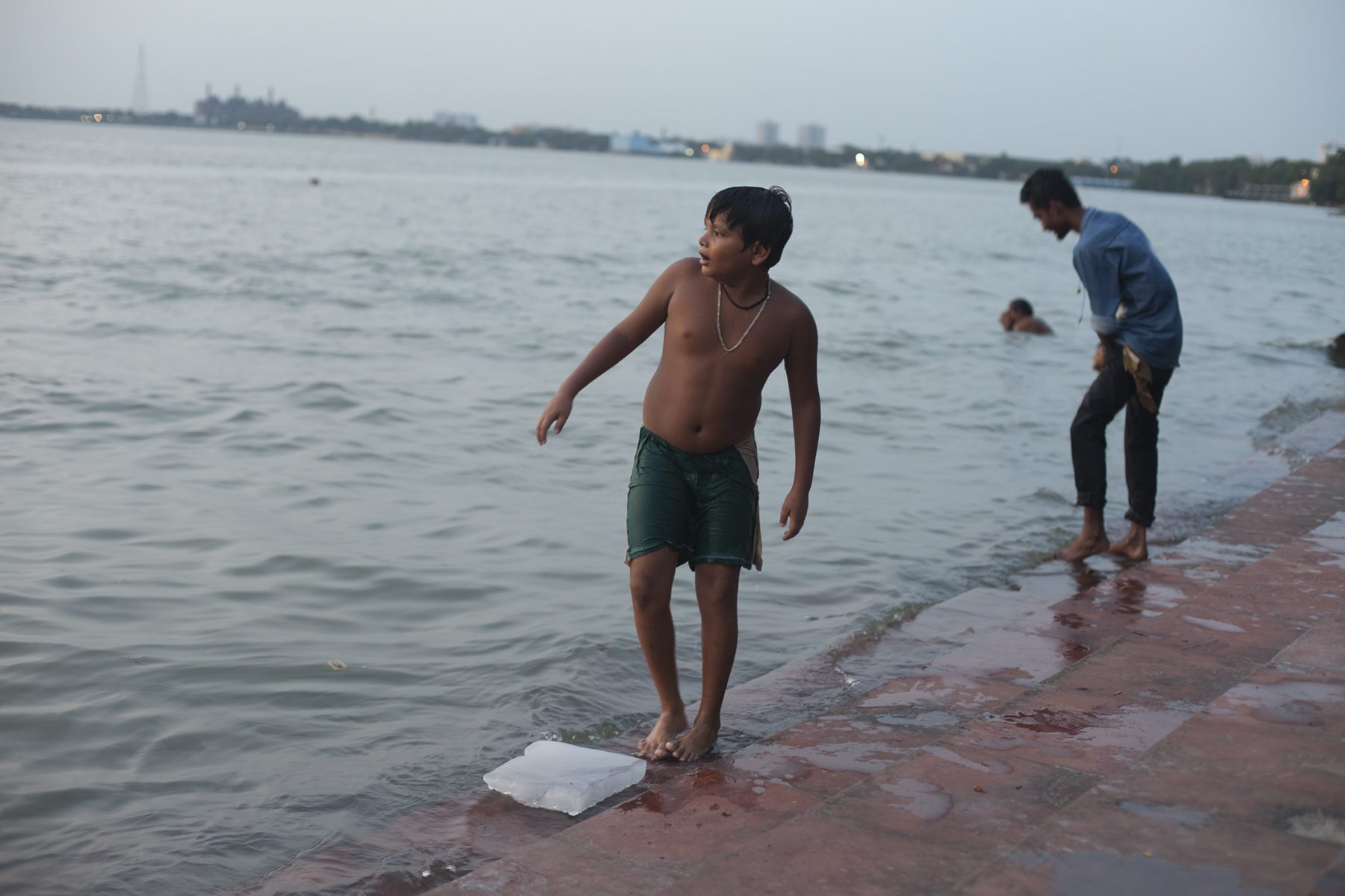 Boy standing near water