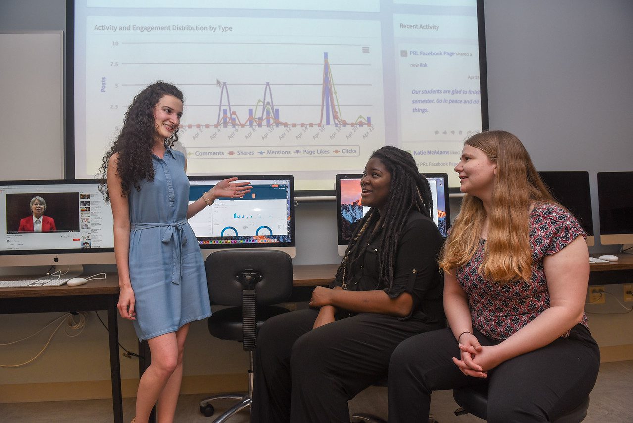 Three students discuss social media analytics