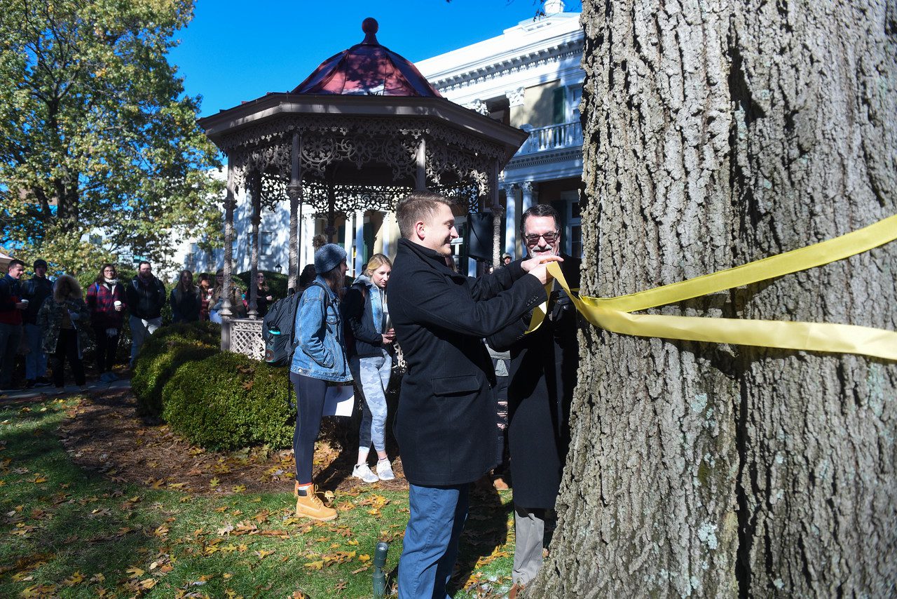 Dr. Burns and President of Bruin Vets Brian Bergeheger tie the first yellow ribbon.