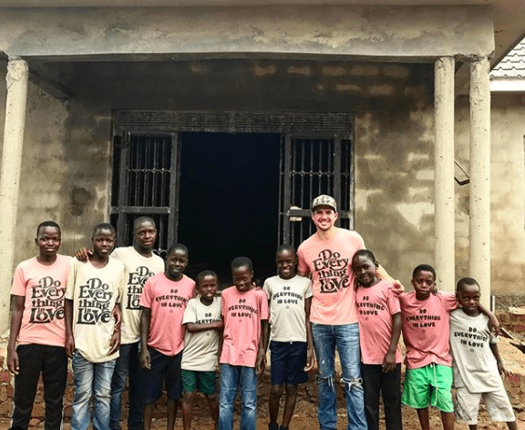 Alumnus Clint Moseley, co-founder of Project R12, with children in Uganda