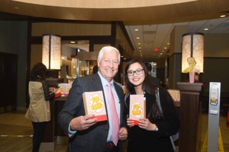 Dr. Fisher and Student hold popcorn boxes