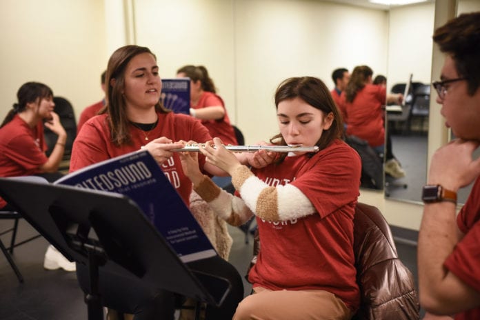 Belmont student teaches young adult the flute