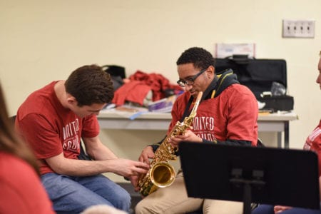 United Sound student receives lesson on saxophone