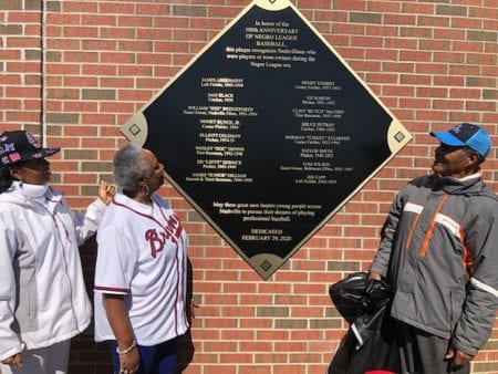 Event leaders admire the new historical plaque