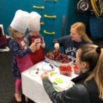 OT students and cooking school friends making caterpillars with grapes and tomatoes.
