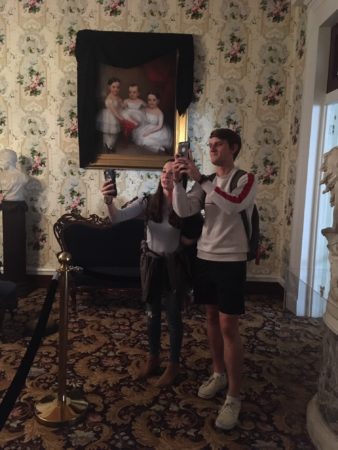 Students taking photos inside Belmont mansion