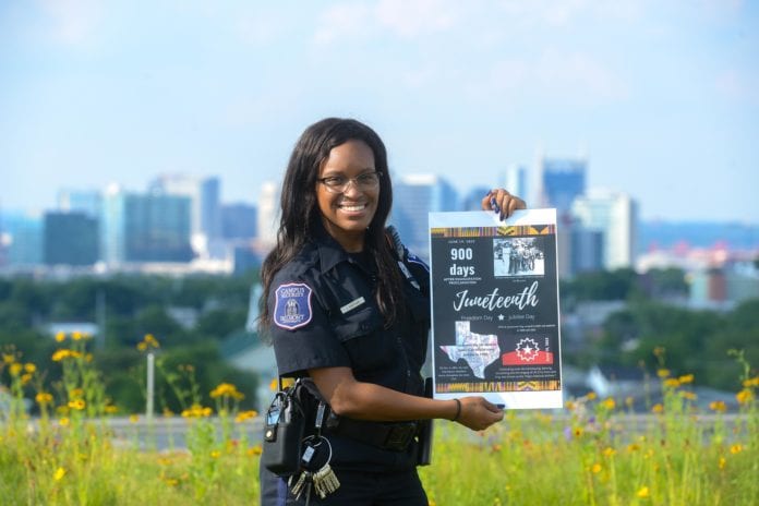 Lauren Sheppard Holds Juneteenth poster