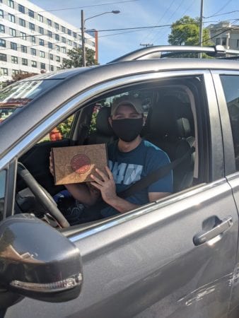 A Belmont student veteran receives a Welcome Back kit at the drive through event