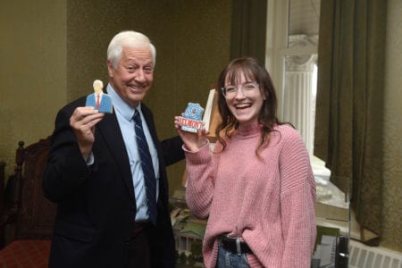 Henegar and Dr. Bob Fisher hold up Cookie in the Kitchen Cookies