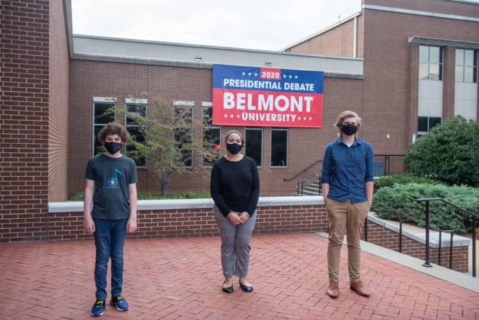 Essay Winners Pose in front of Debate banner on Belmont's campus