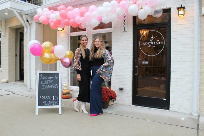 Emily James and sister in front of store