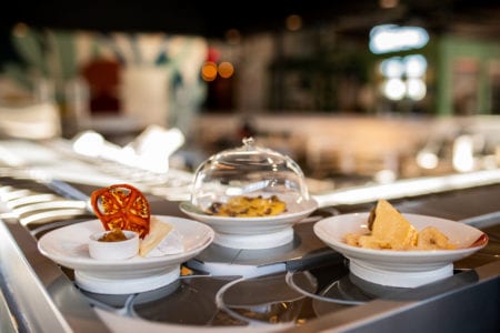 Three cheese pairings sit on conveyer belt