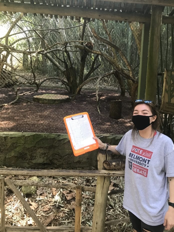 student poses at zoo