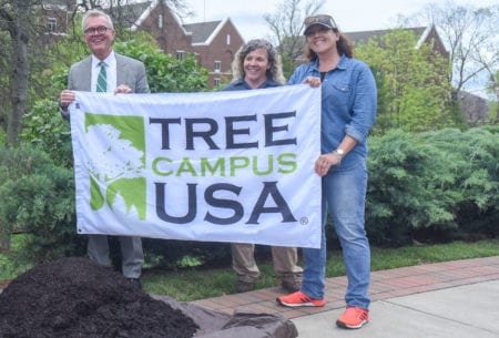 Belmont staff hold Tree Campus USA banner