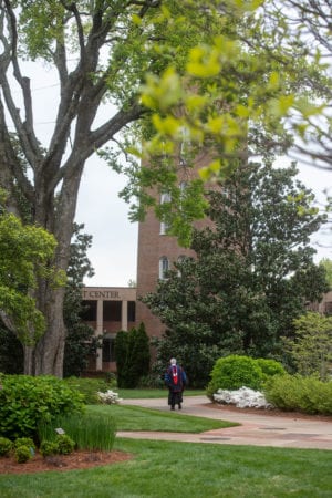 Dr. Fisher walking near Bell tower