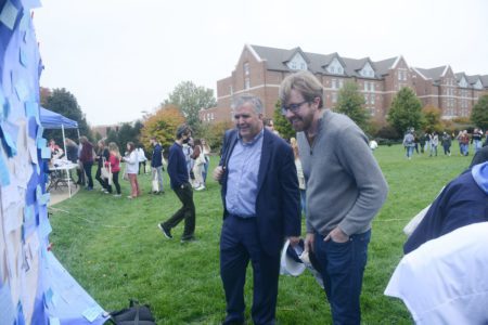 Dr. Jones and James Pierce view the Dove Mural at Campus Carnival