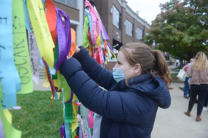girl tying ribbon to display