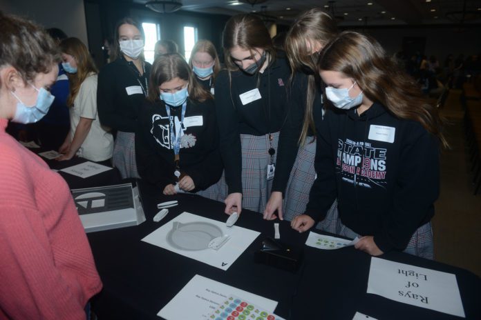 Celebrating Women of Physical Science event girls at science table