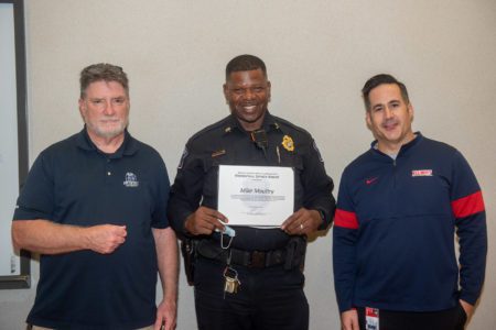 Captain Mike Moultry receives a Meritorious Service Award. (Masks were removed briefly for the photo.)