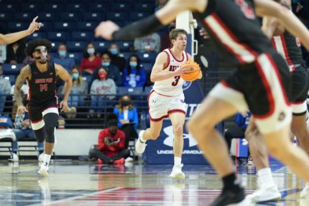 Belmont basketball player Luke Smith takes the ball down the court. 