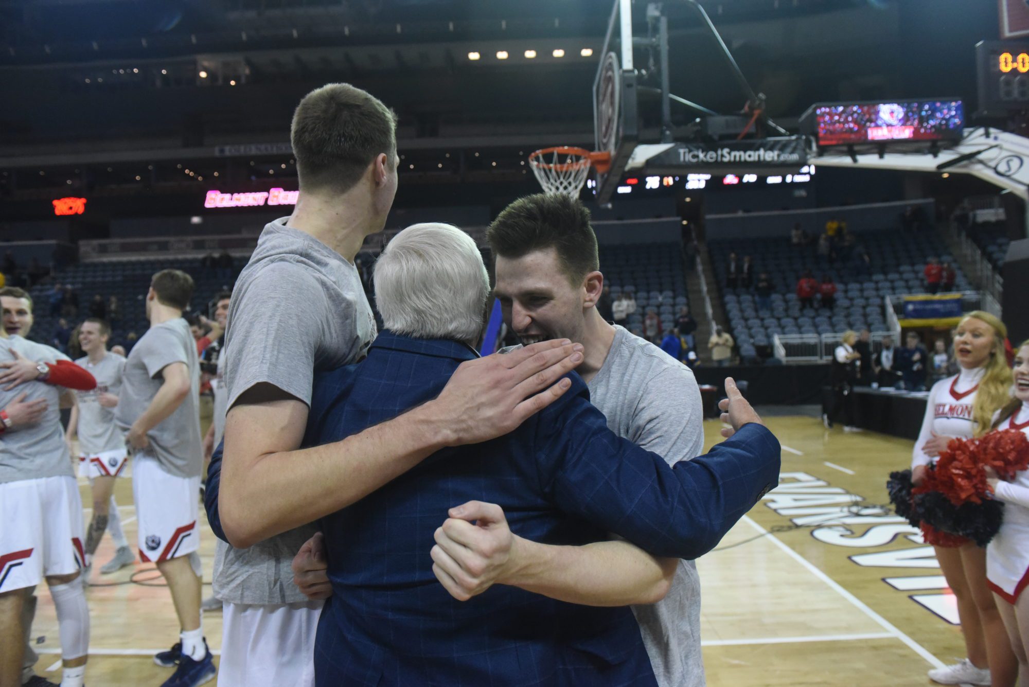 Belmont basketball players embrace after a win in the OVC championship game.