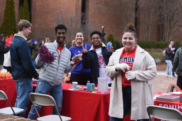 students smile at tailgate