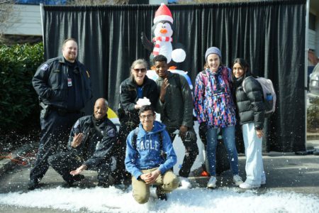 Students and staff pose with snow