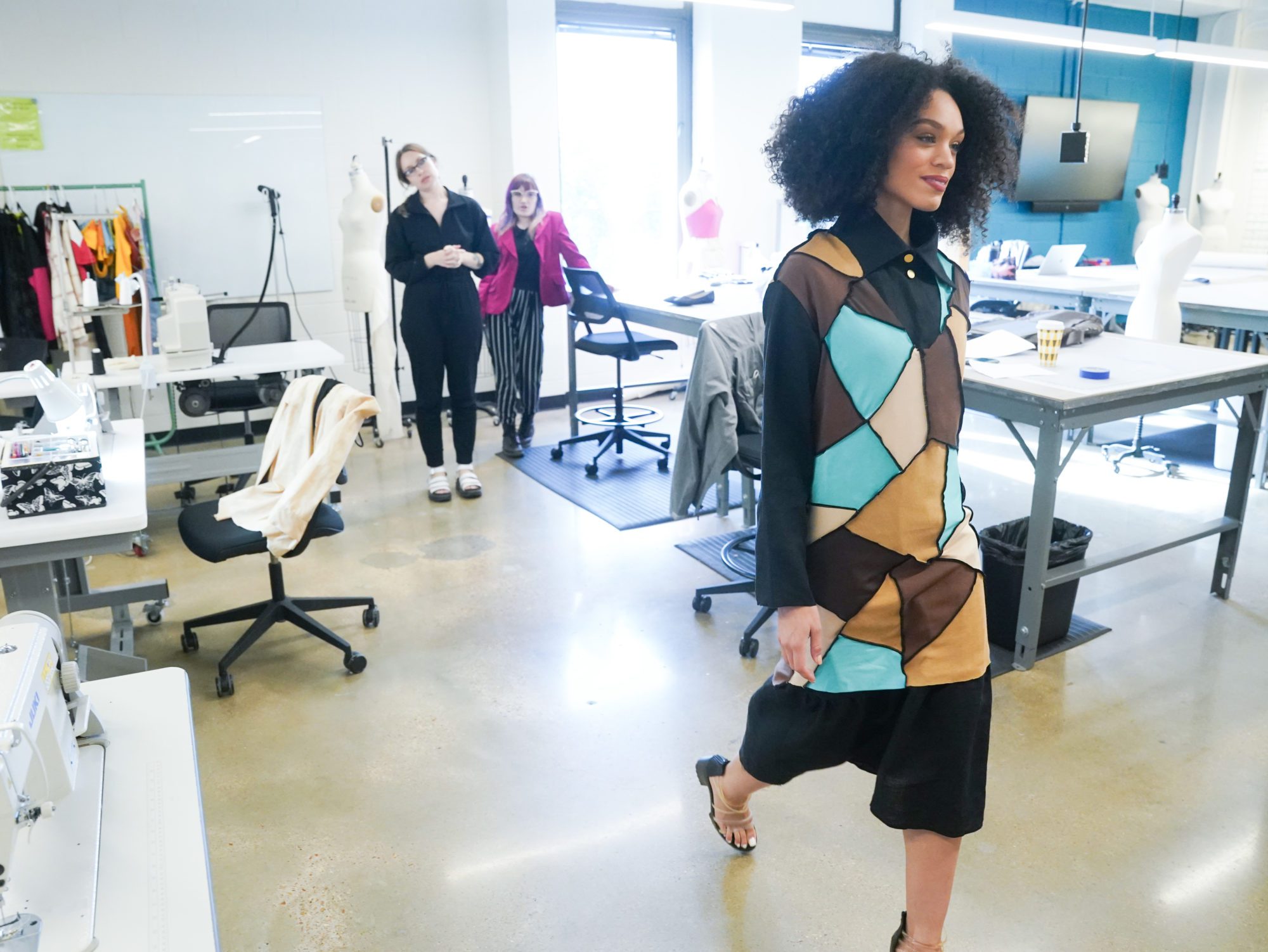 A model wearing fashion student Kat Westmoreland's design takes a practice walk through a classroom at O'More. 