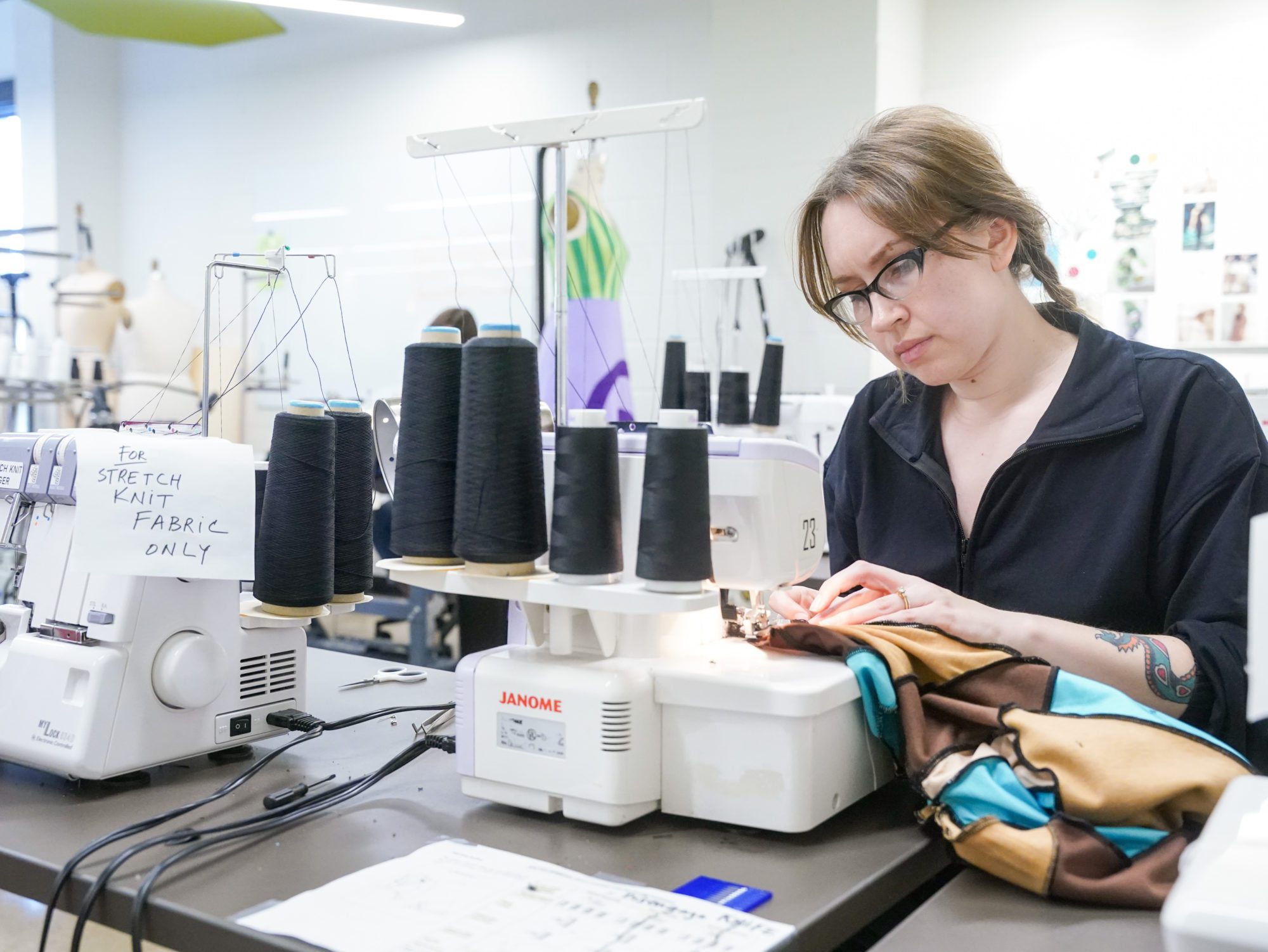 Fashion student Kat Westmoreland uses a sewing machine at O'More to make adjustments to her design. 