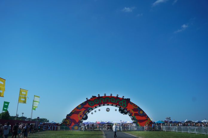 The arched entrance at Bonnaroo against a blue sky.