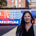 Erica next to her Murals