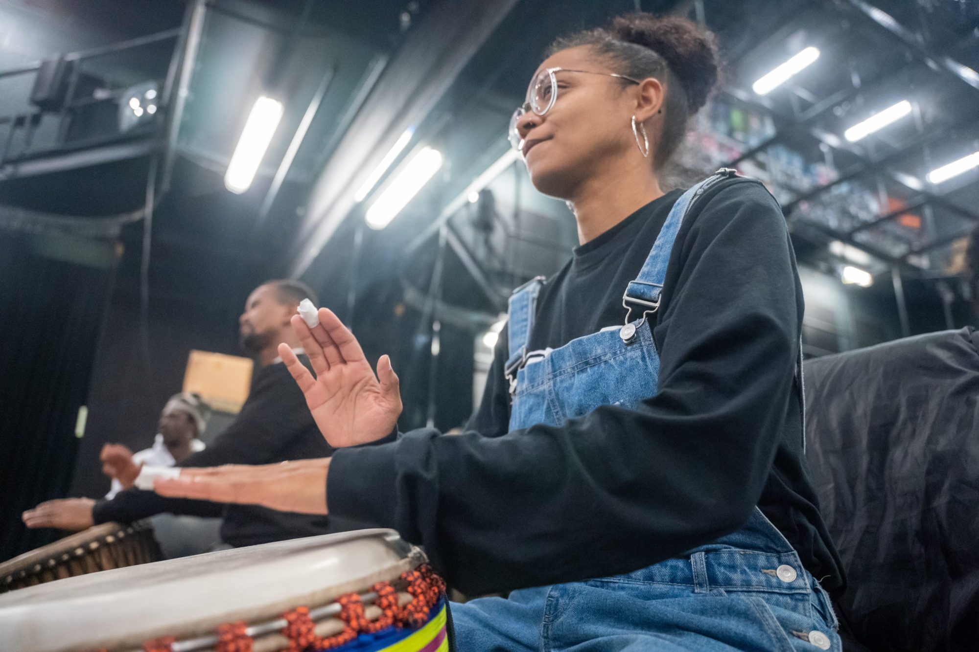 Drummer Agathe Moubemb plays a West African beat with fellow Yeli Ensemble drummers Sory Diabate and Ibrahima Dioubate.