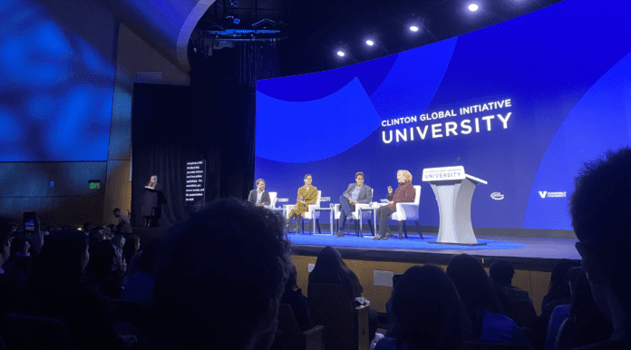 a panel presents on stage during clinton Global Initiative University (CGI U)