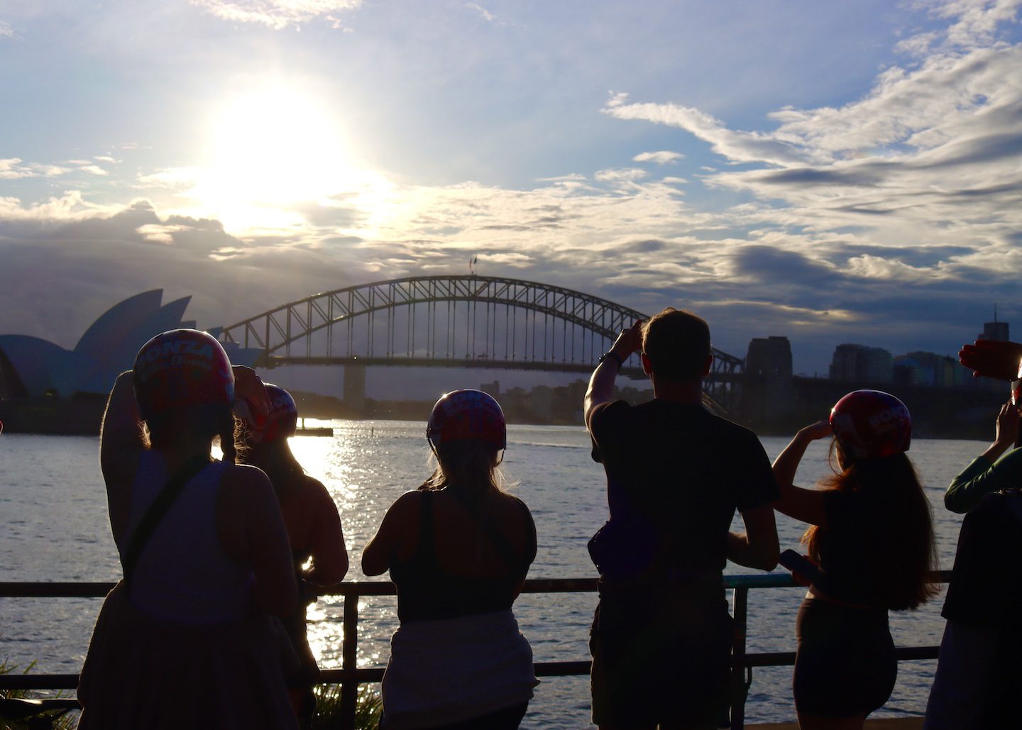 student silhouettes look at sydney opera house and bridge