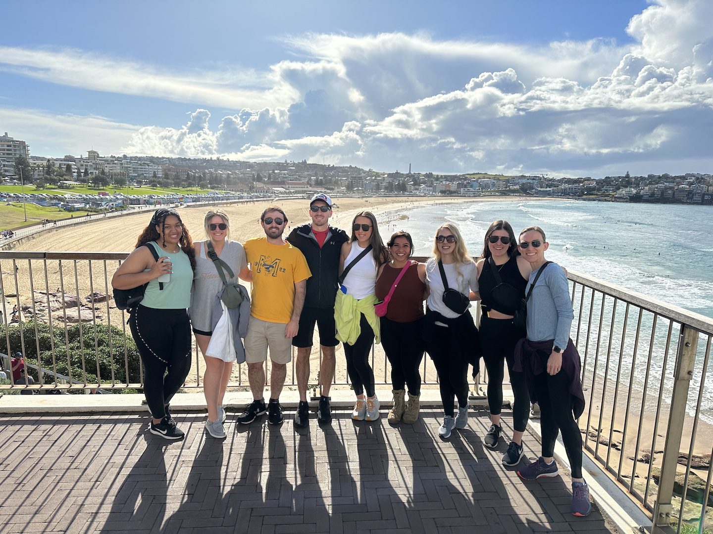 law students pose as a group on bondi beach on a hike