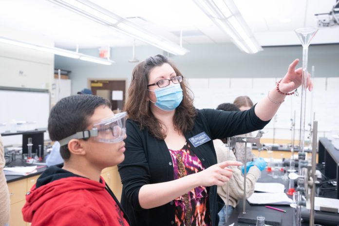 Dr. Maria Danielle Garrett with high school students in a lab